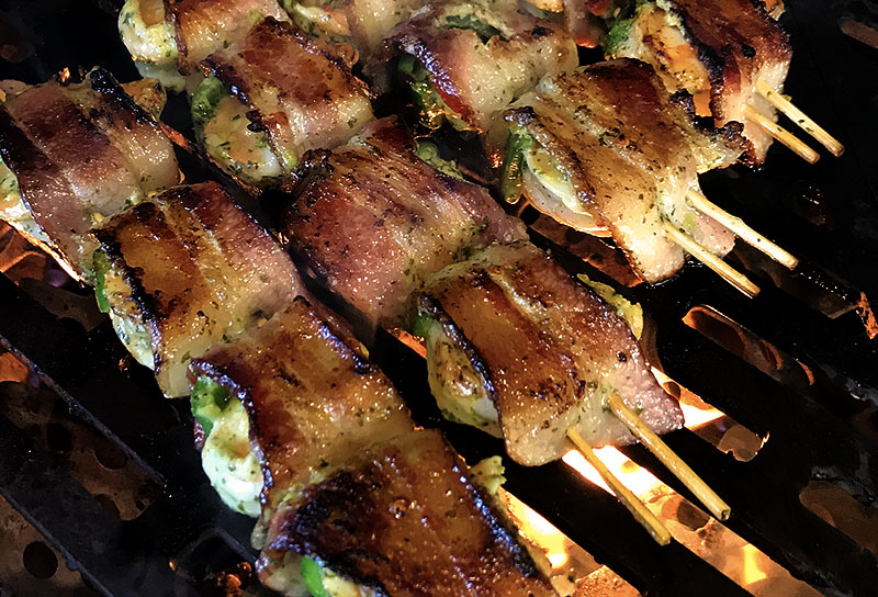 Shrimp and bacon skewers grilling on the Hybrid Fire Grill