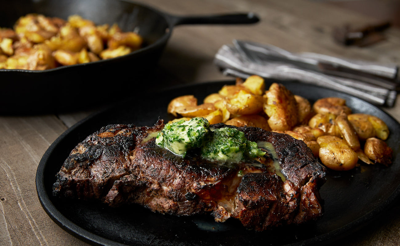 Wood-Smoked Beef Ribeyes with Jalapeño Horseradish Butter and Smashed Potatoes