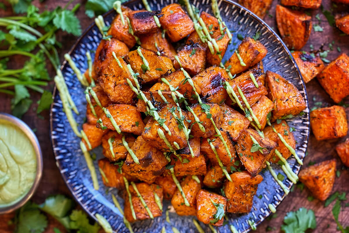 Spicy Roasted Sweet Potatoes with Avocado & Cilantro Cream