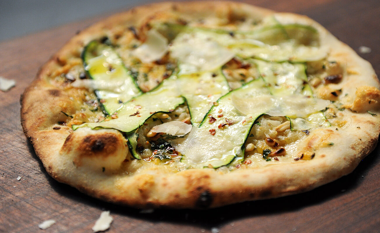 Image of Zucchini Pizza with Roasted Garlic and Pine Nuts