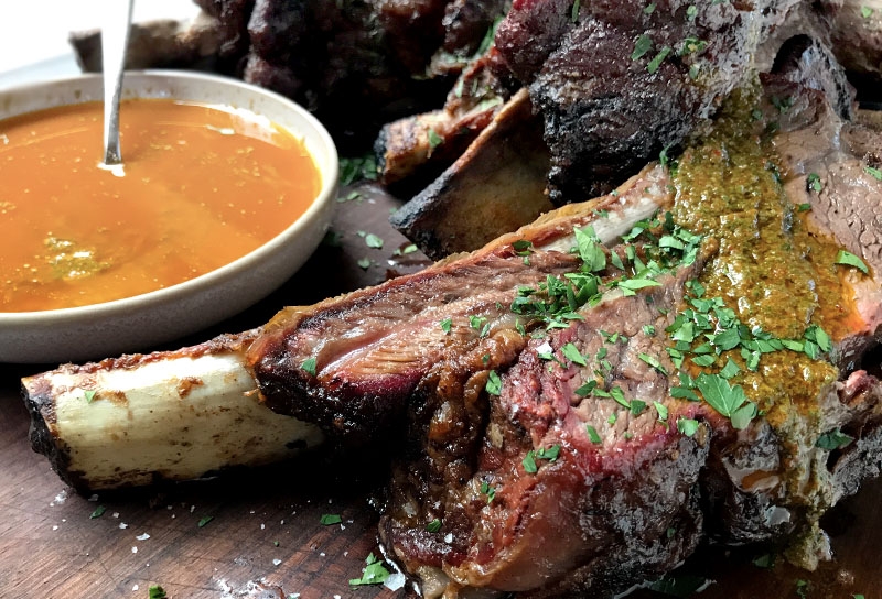 Image of Wood-fired Rotisserie Beef Ribs with Smoky Red Chimichurri